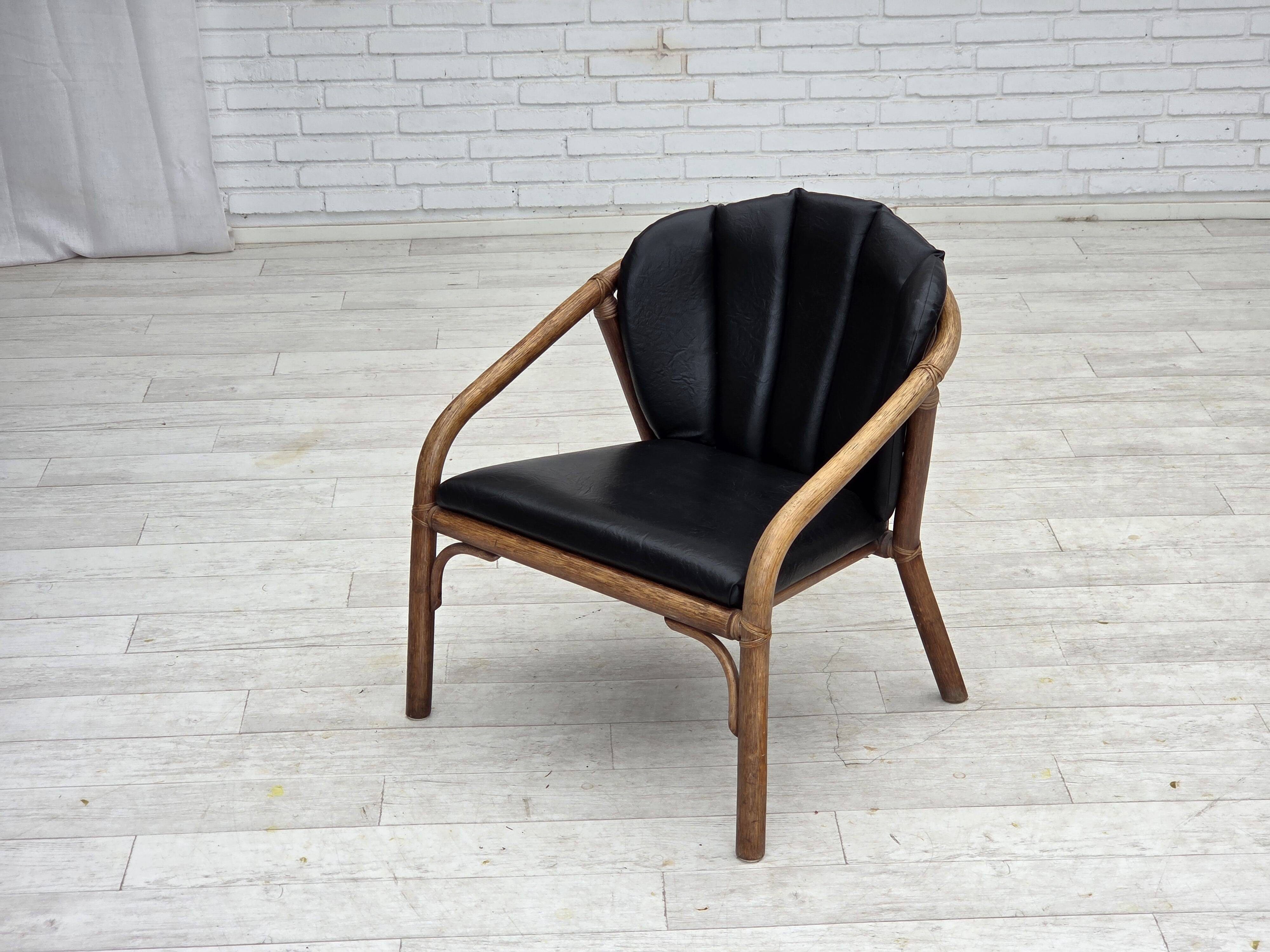 1970s, Danish armchair, rattan, black artificial leather.