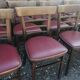 Set of 19 vintage wooden bistro chairs with red faux leather.