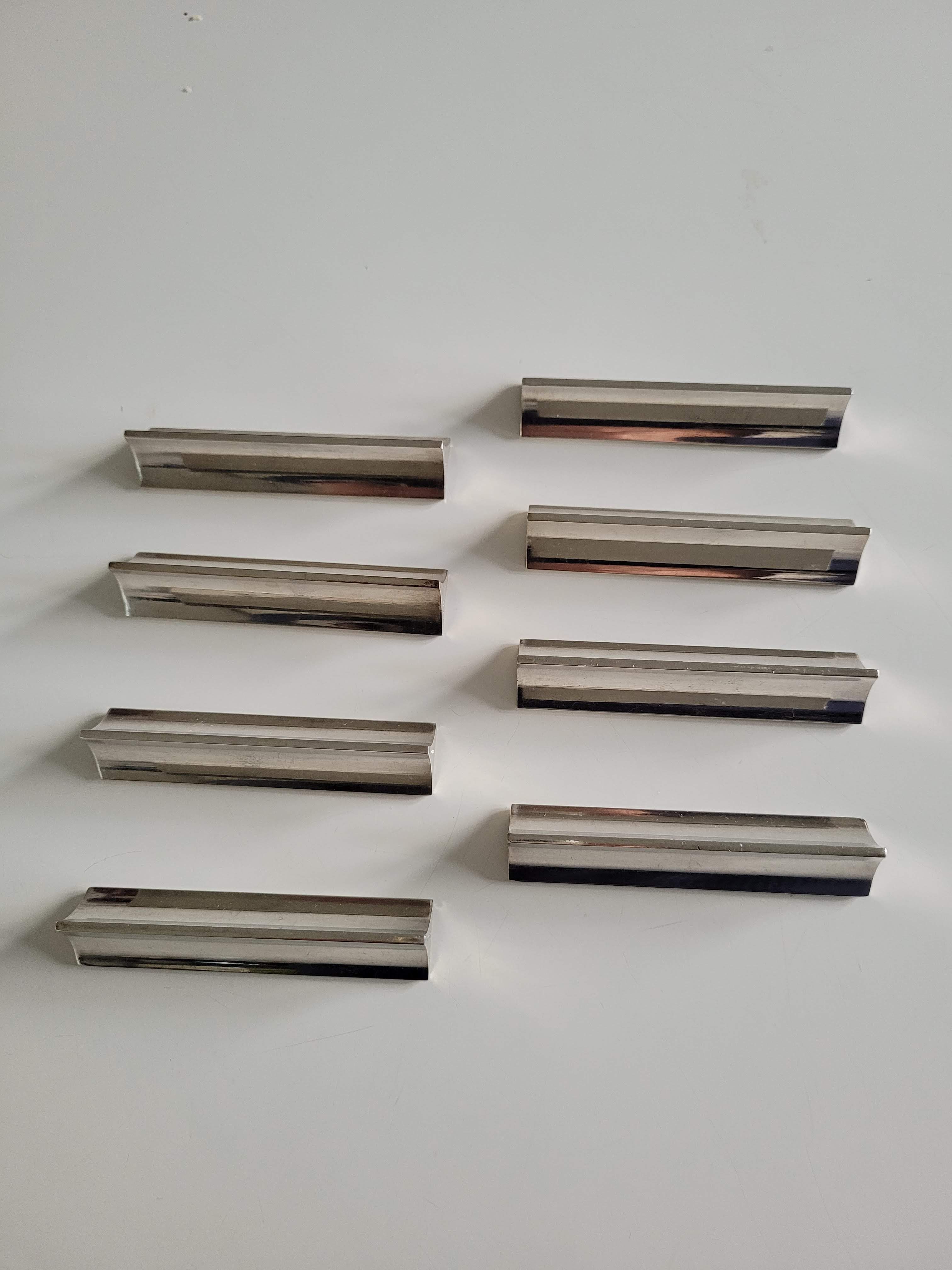 Eight Boulenger knife holders in art deco silver metal