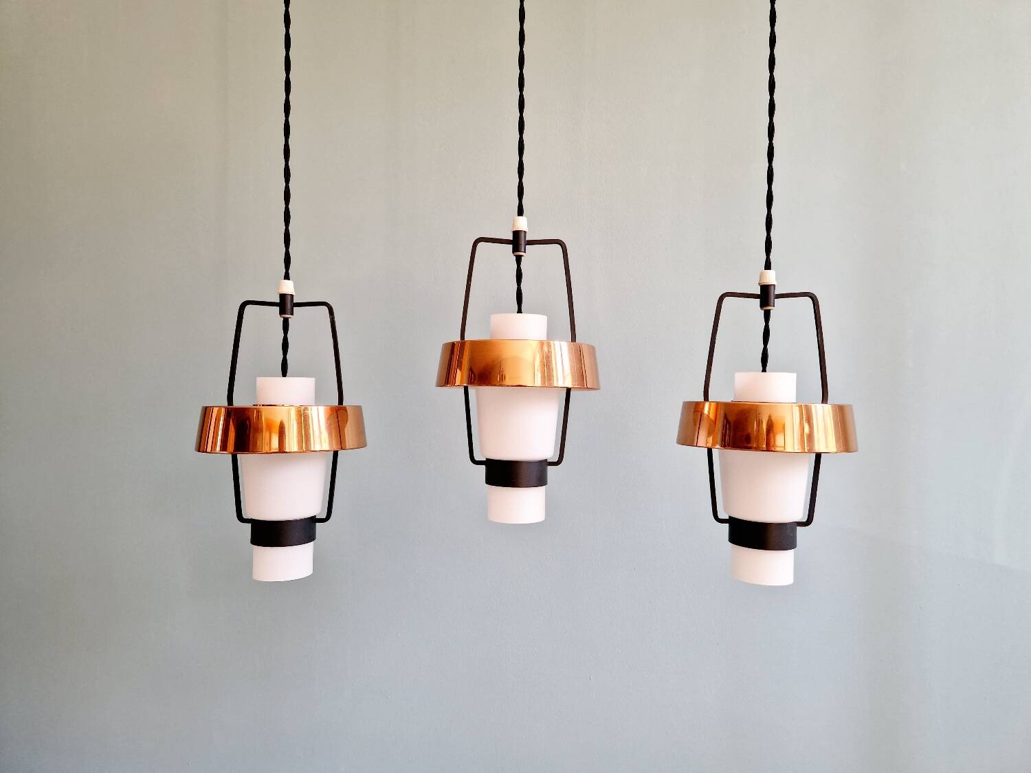 Trio of Scandinavian pendant lights in opaline and copper metal, 1960s