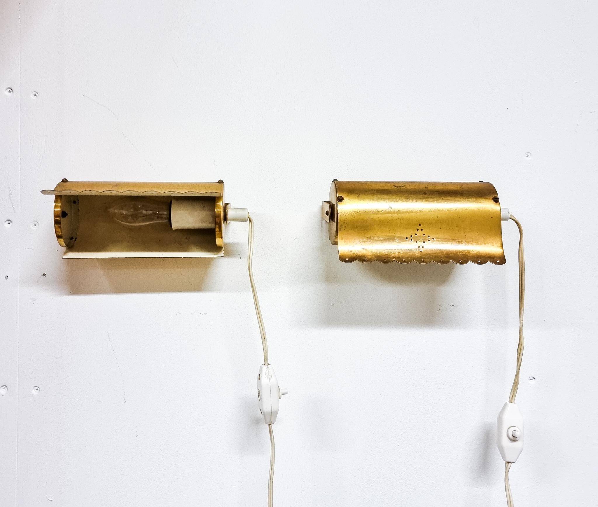 A pair of charming wall sconces/branches in brass with a star pattern, modern Scandinavian style.