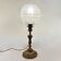 Antique brass foot lamp with glass globe and diamond point.