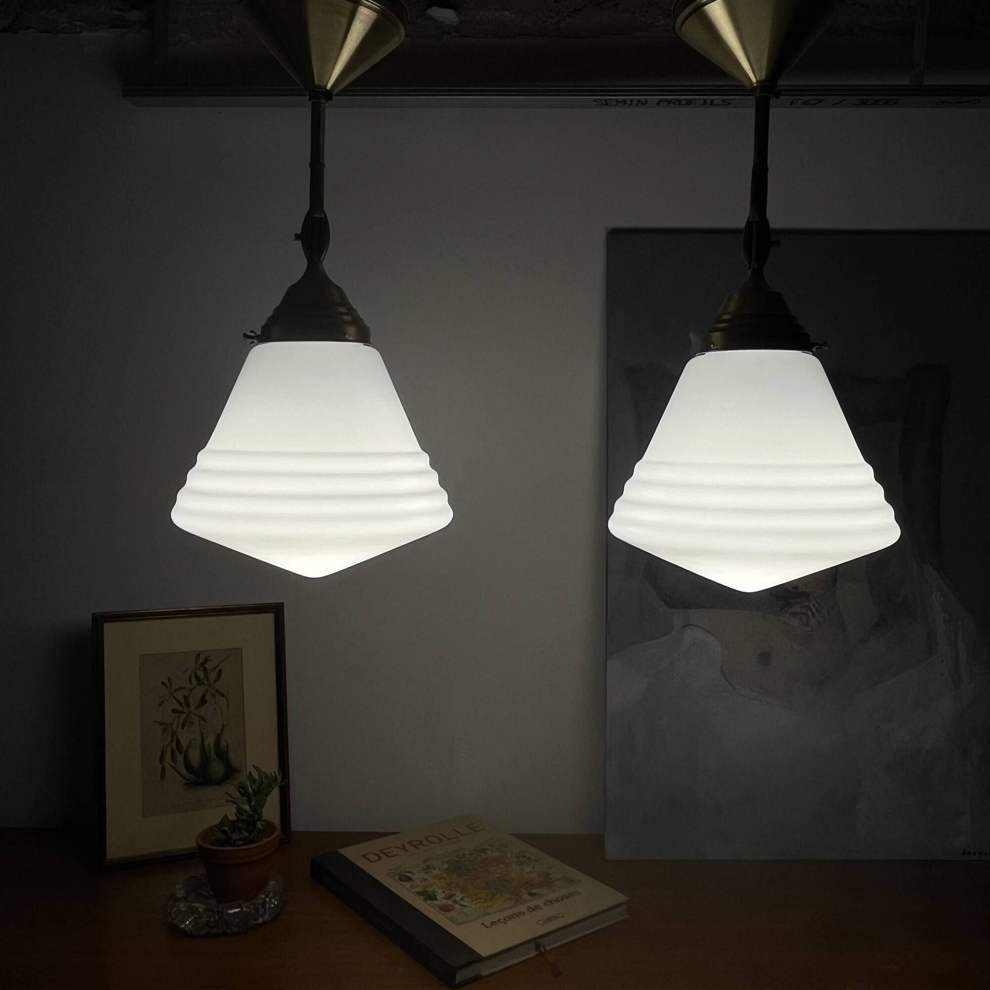 Pair of opaline glass pendant lights in white by Philips and brass from the 1920s.