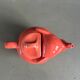 Large coral-coloured elephant teapot.