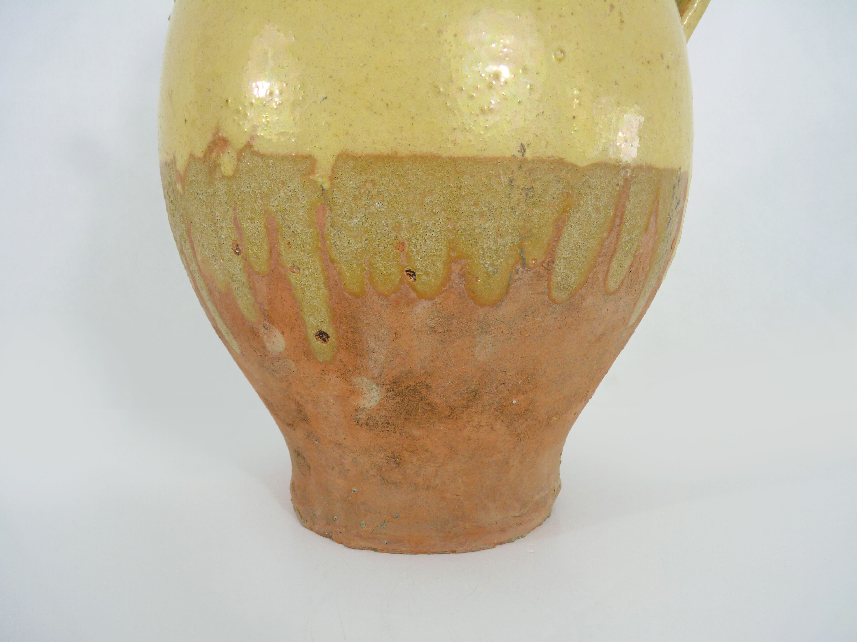 Old jug, chevrette, water pitcher in glazed yellow sandstone. Early twentieth century