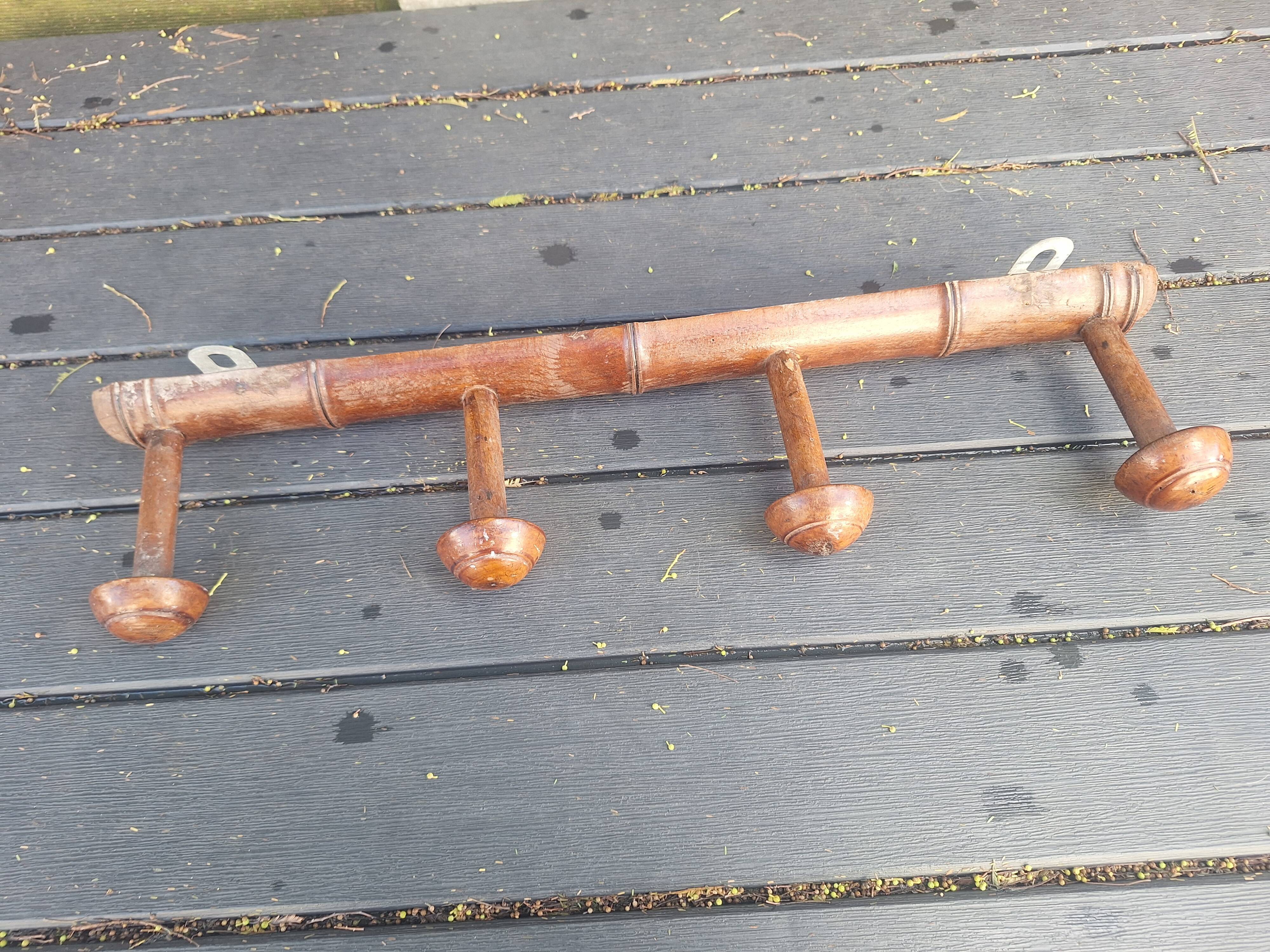 Old wooden coat hook imitating bamboo.