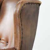 Large and comfortable sheepskin leather wingback chair with black piping