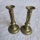 Pair of antique brass candlesticks with adjustable push mechanism from the 19th century.