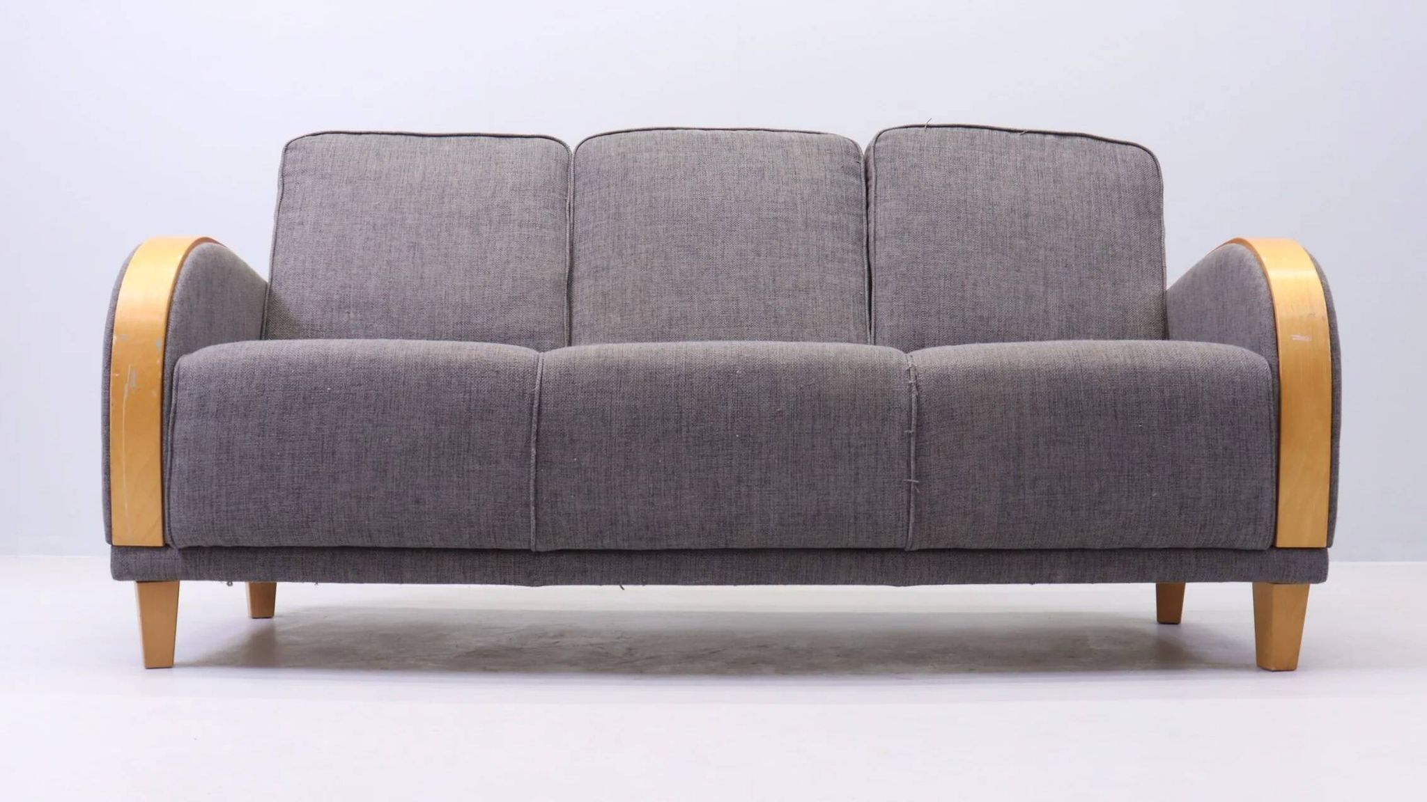 Three-seater Art Deco style sofa in grey fabric and curved wood.