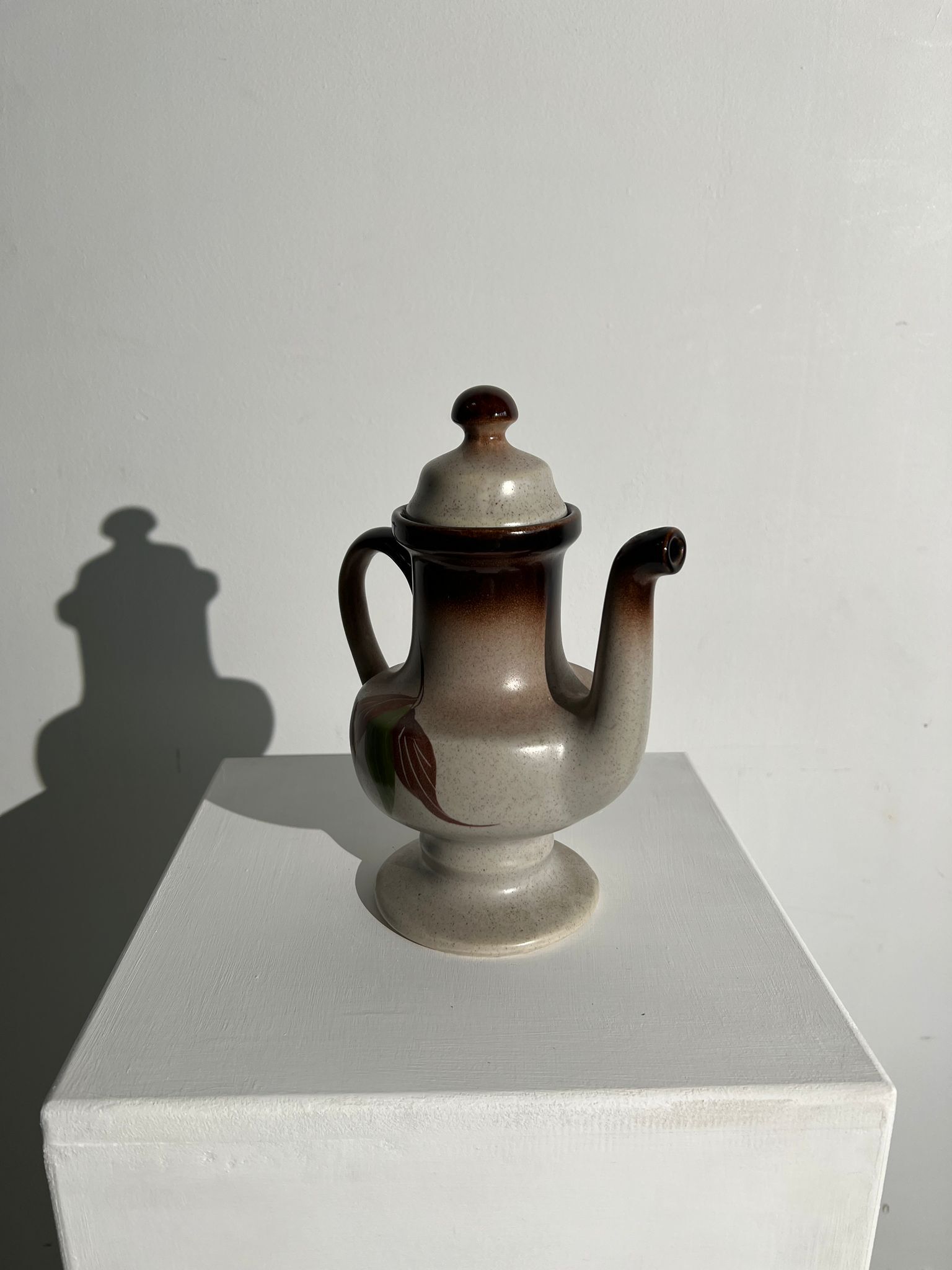 Vintage stoneware teapot with flower and fruit patterns