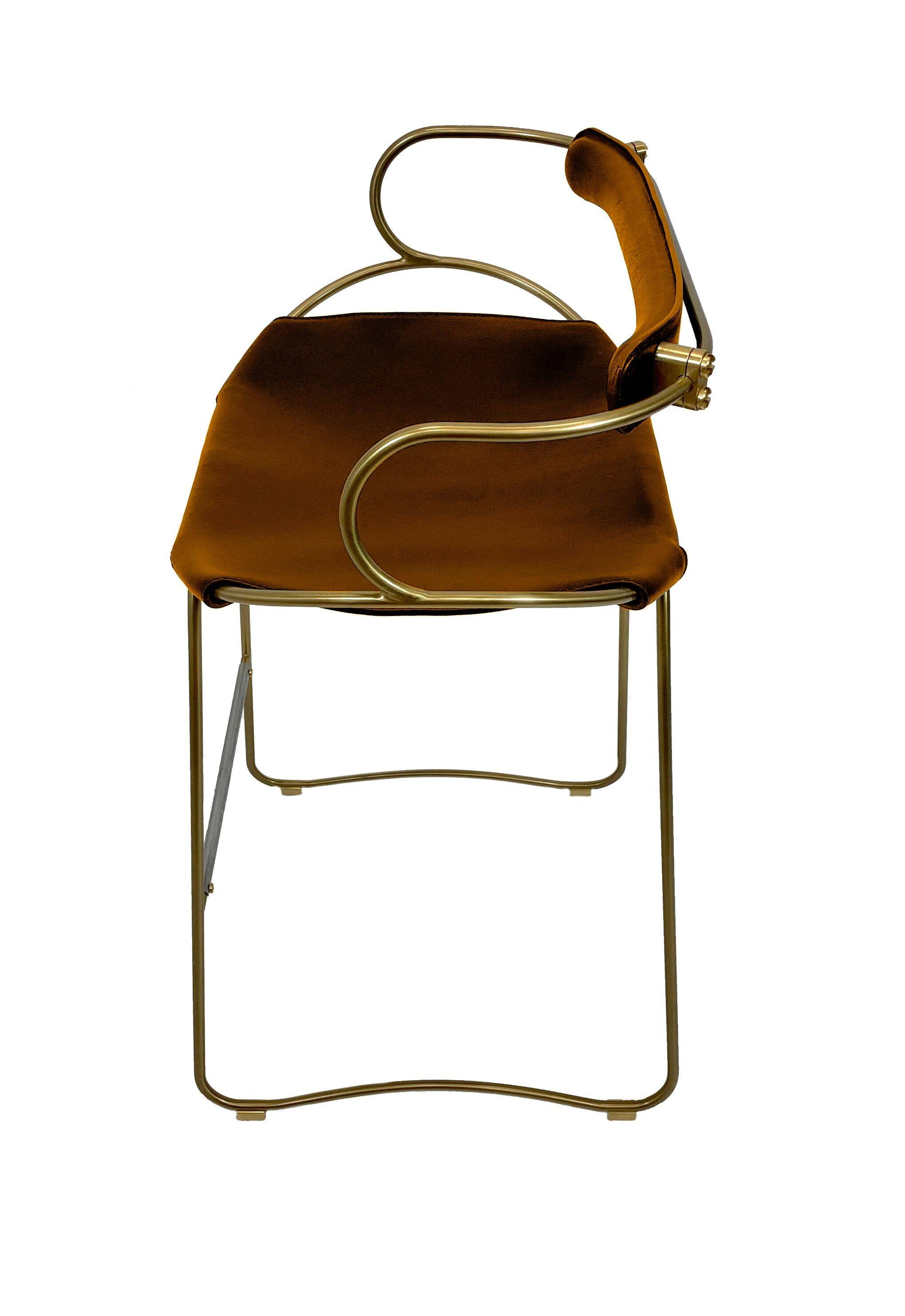 Kitchen bar stool with a brass metal backrest and natural tan tobacco leather.