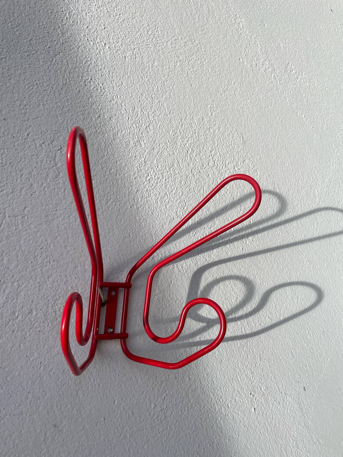 Pair of red metal wall hooks