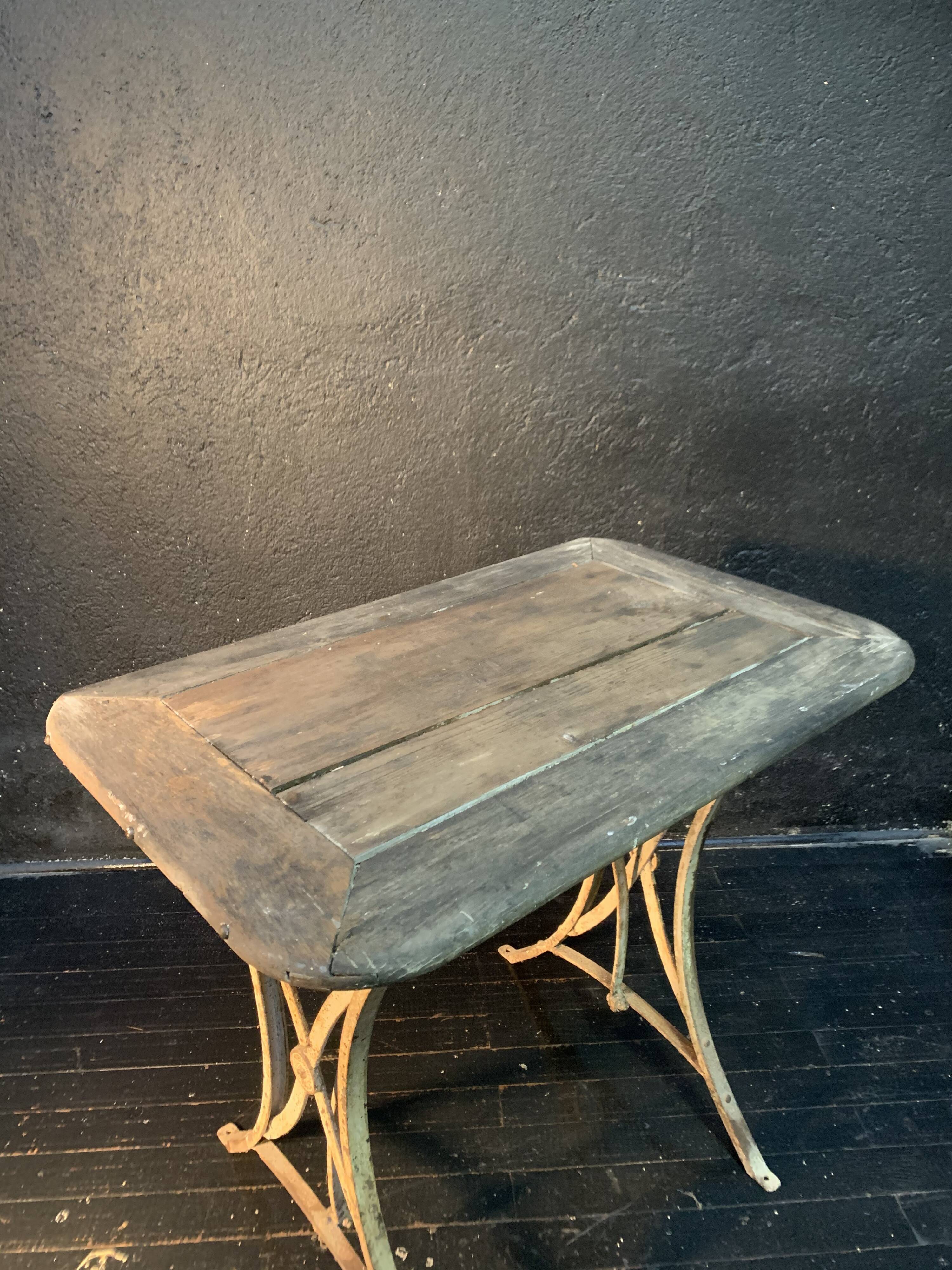 Ancient wrought iron and wood garden table