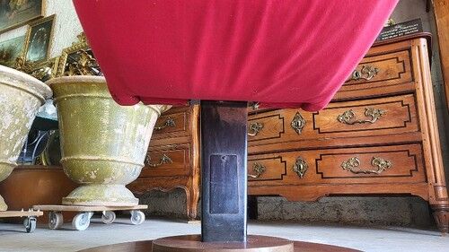 Old cinema chair with a red reclining seat.