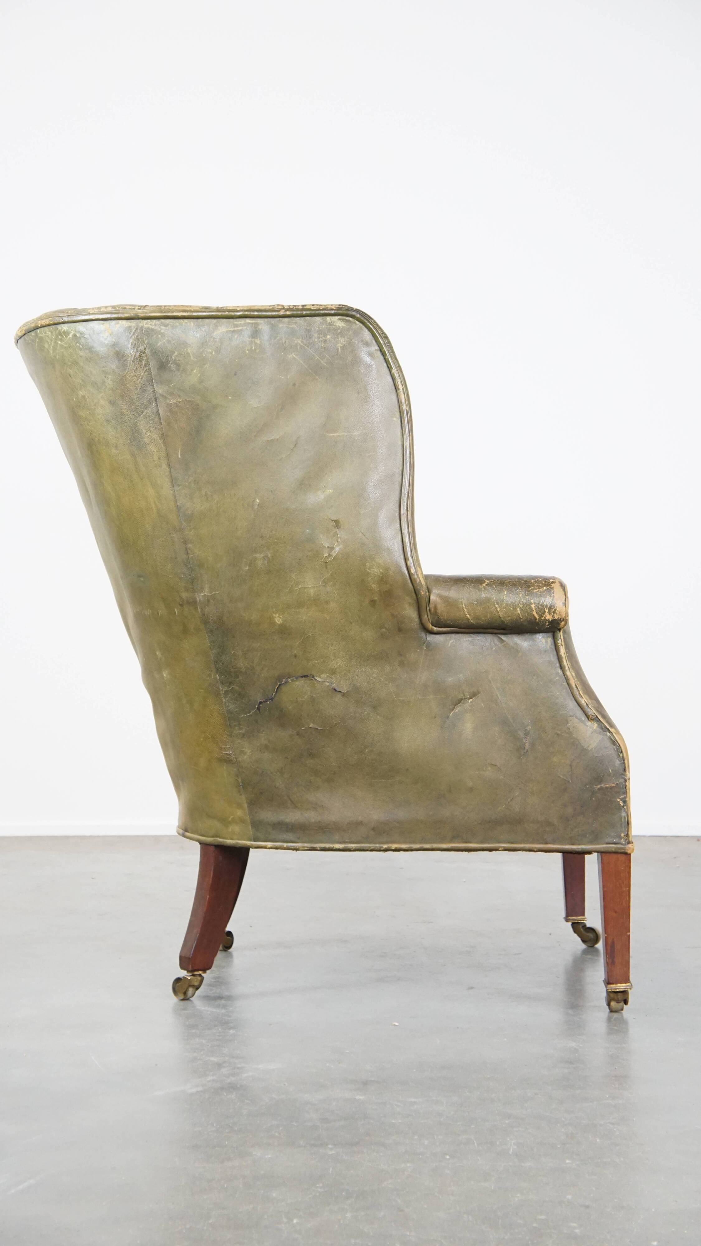 Green antique barrel back wingback chair on wheels