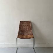 Chair design in rattan, woven wicker and chrome wire metal.