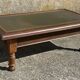 Vintage English coffee table in oak and green leather – 1950s/60s