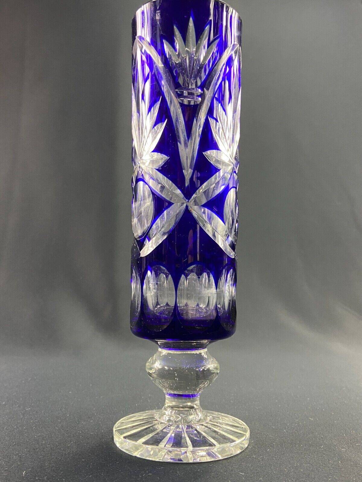 Tubular vase on a pedestal in cut blue Bohemian crystal.