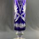 Tubular vase on a pedestal in cut blue Bohemian crystal.