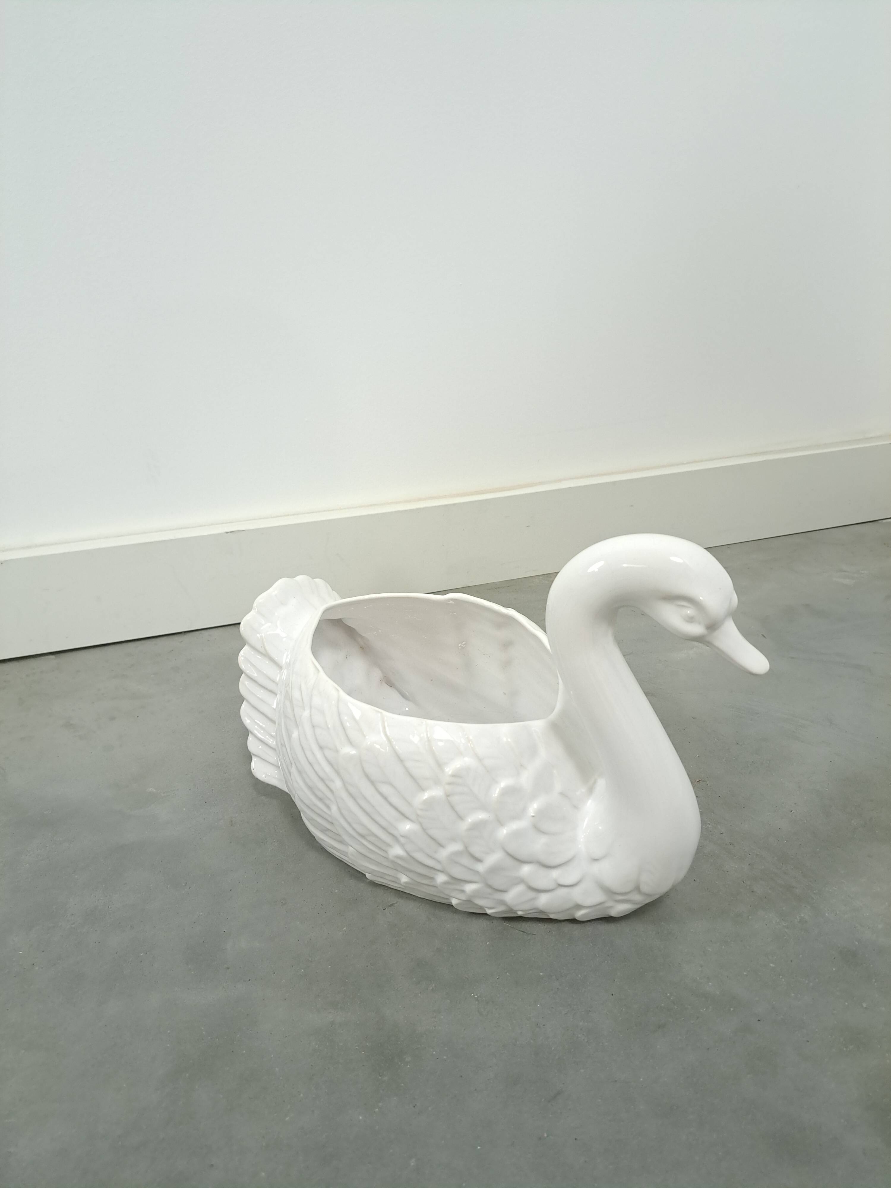 vintage porcelain flower pot in the shape of a swan