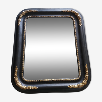 Antique mirror in black and gilded wood