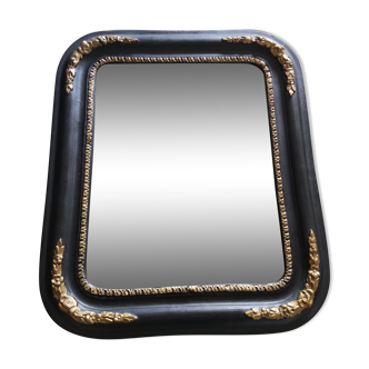 Antique mirror in black and gilded wood