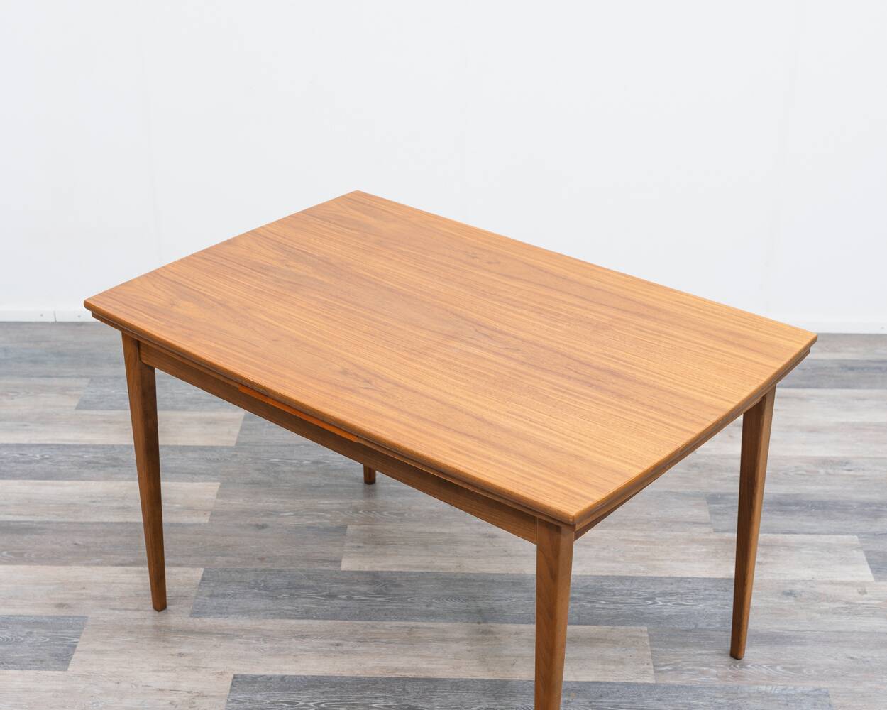 Dining table, 1960s, in walnut, slightly elliptical shape.