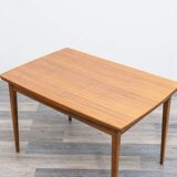 Dining table, 1960s, in walnut, slightly elliptical shape.
