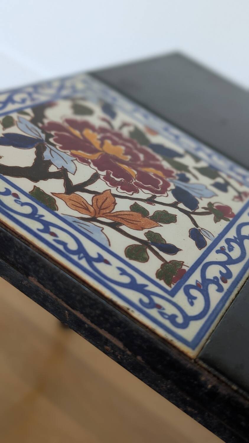 Wrought iron coffee table with square Gien ceramic patterns.