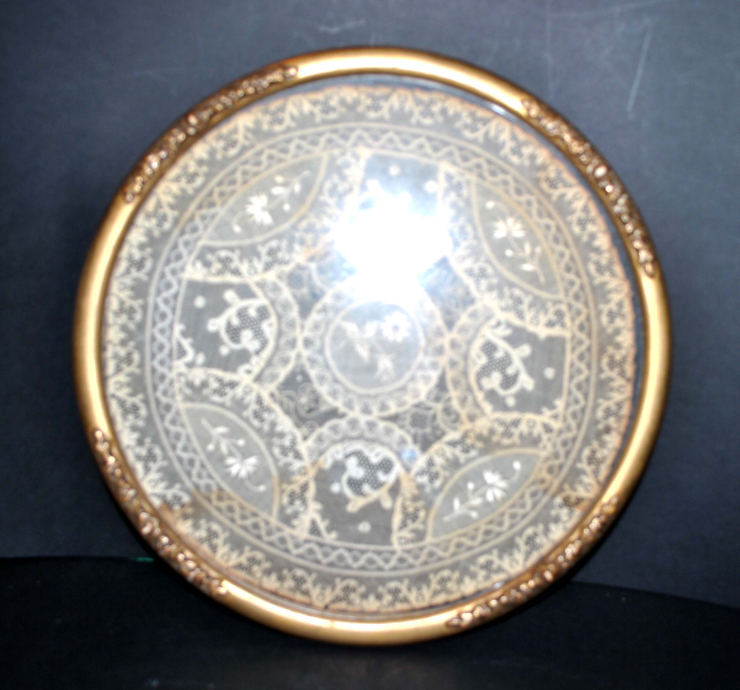 Antique lace top under glass and gilded stucco frame