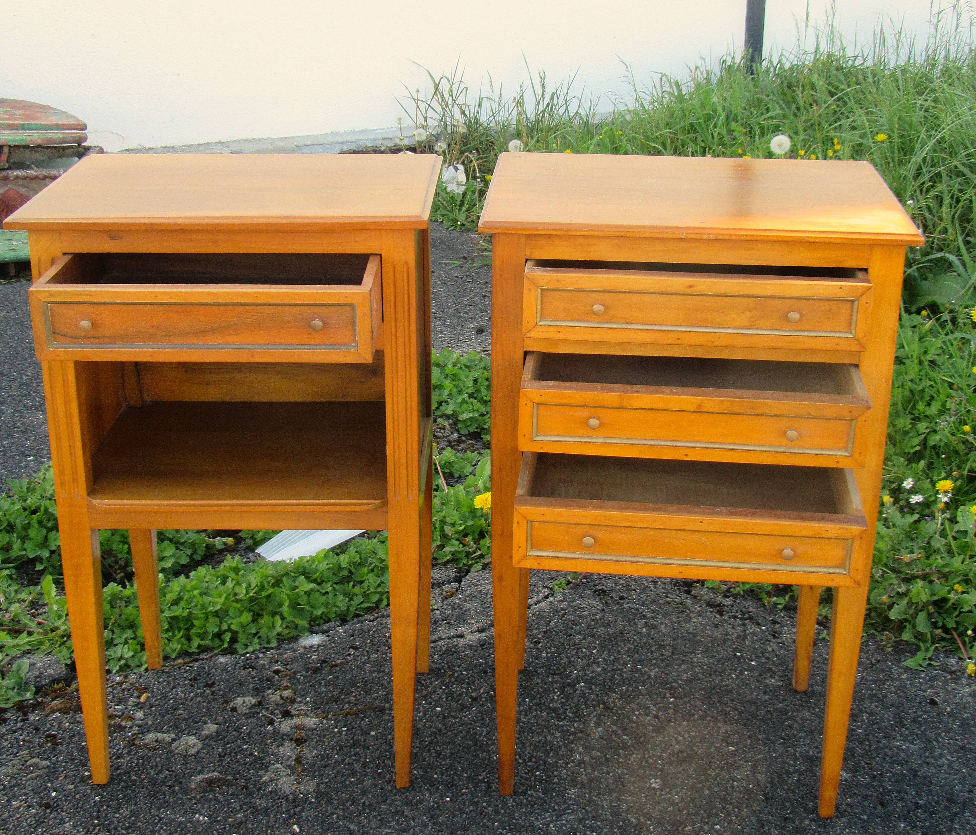 Pair of walnut bedside tables in Louis XVI style with brass inlay.
