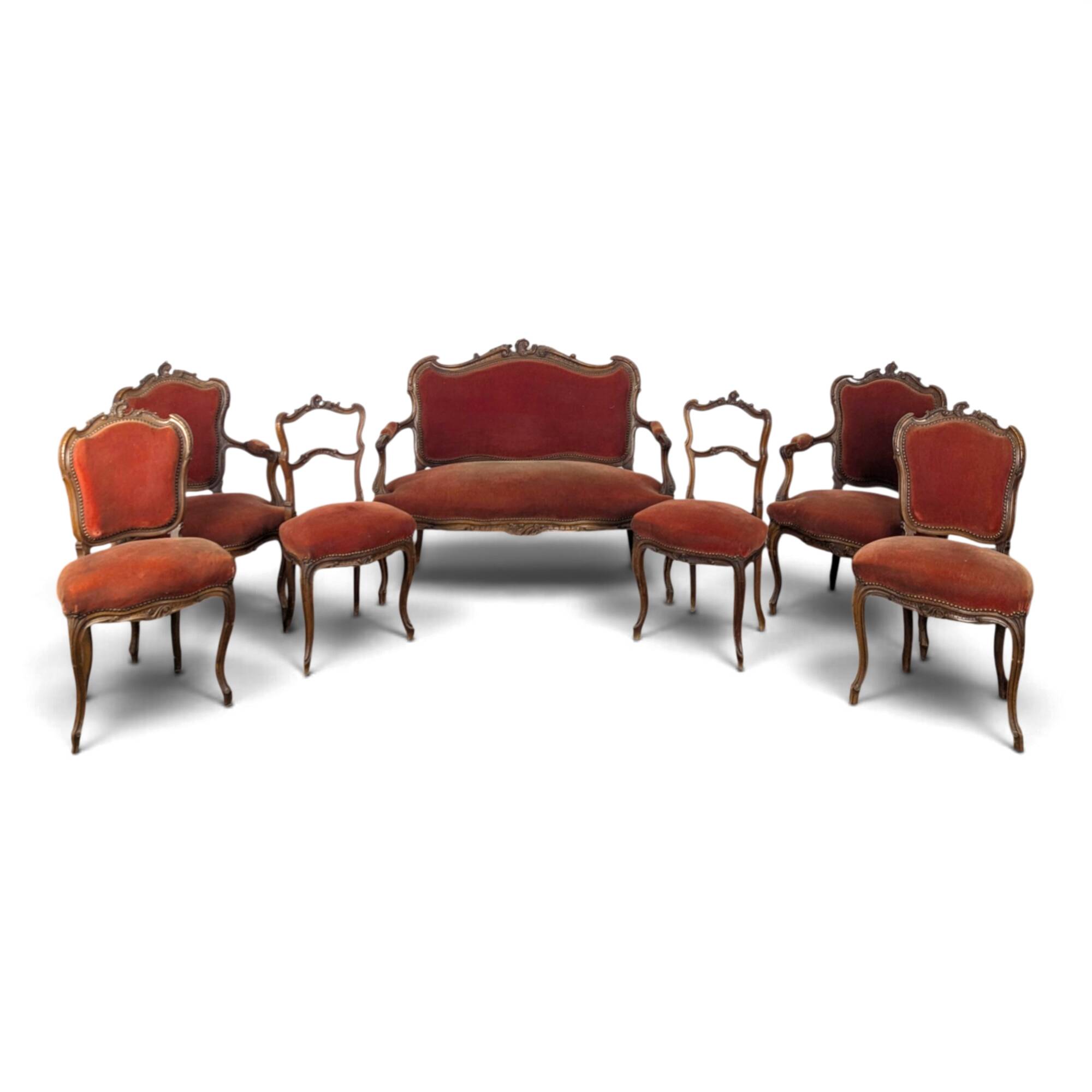 Louis XV style salon in carved walnut with orange velvet, seven pieces.