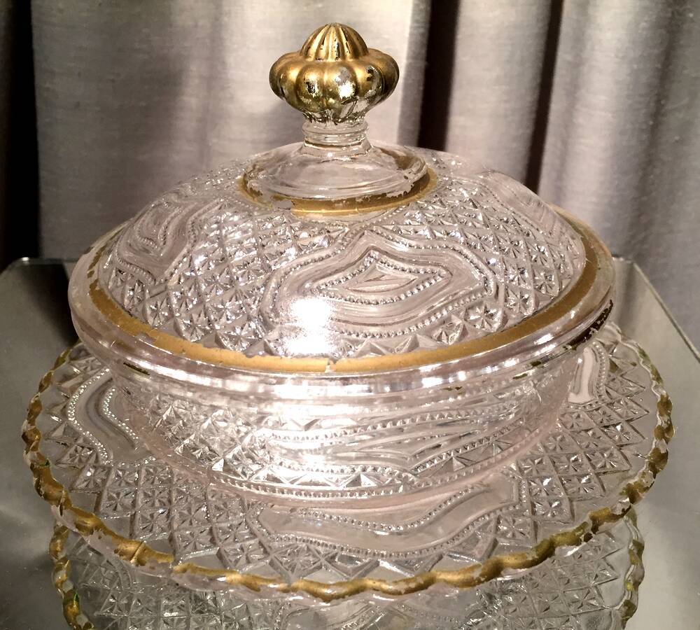 Butter dish or candy dish in pressed glass molded with golden rim