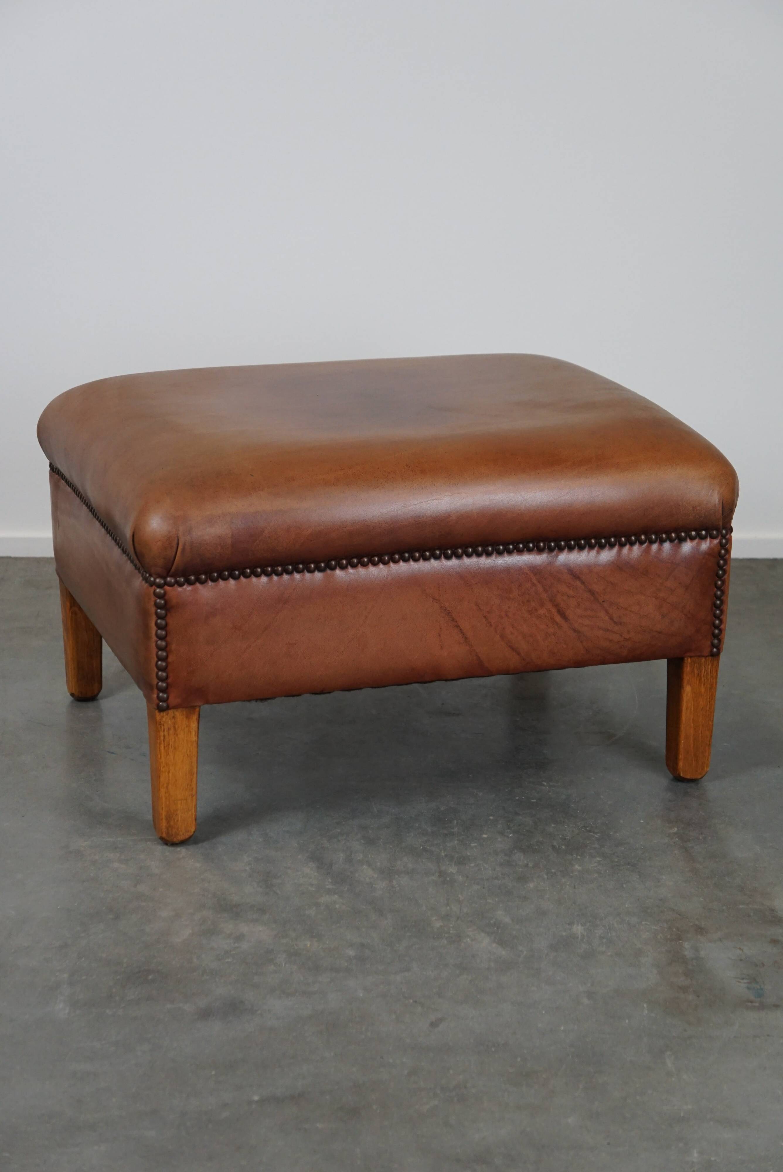 English-style leather ottoman in cognac-colored leather