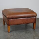 English-style leather ottoman in cognac-colored leather