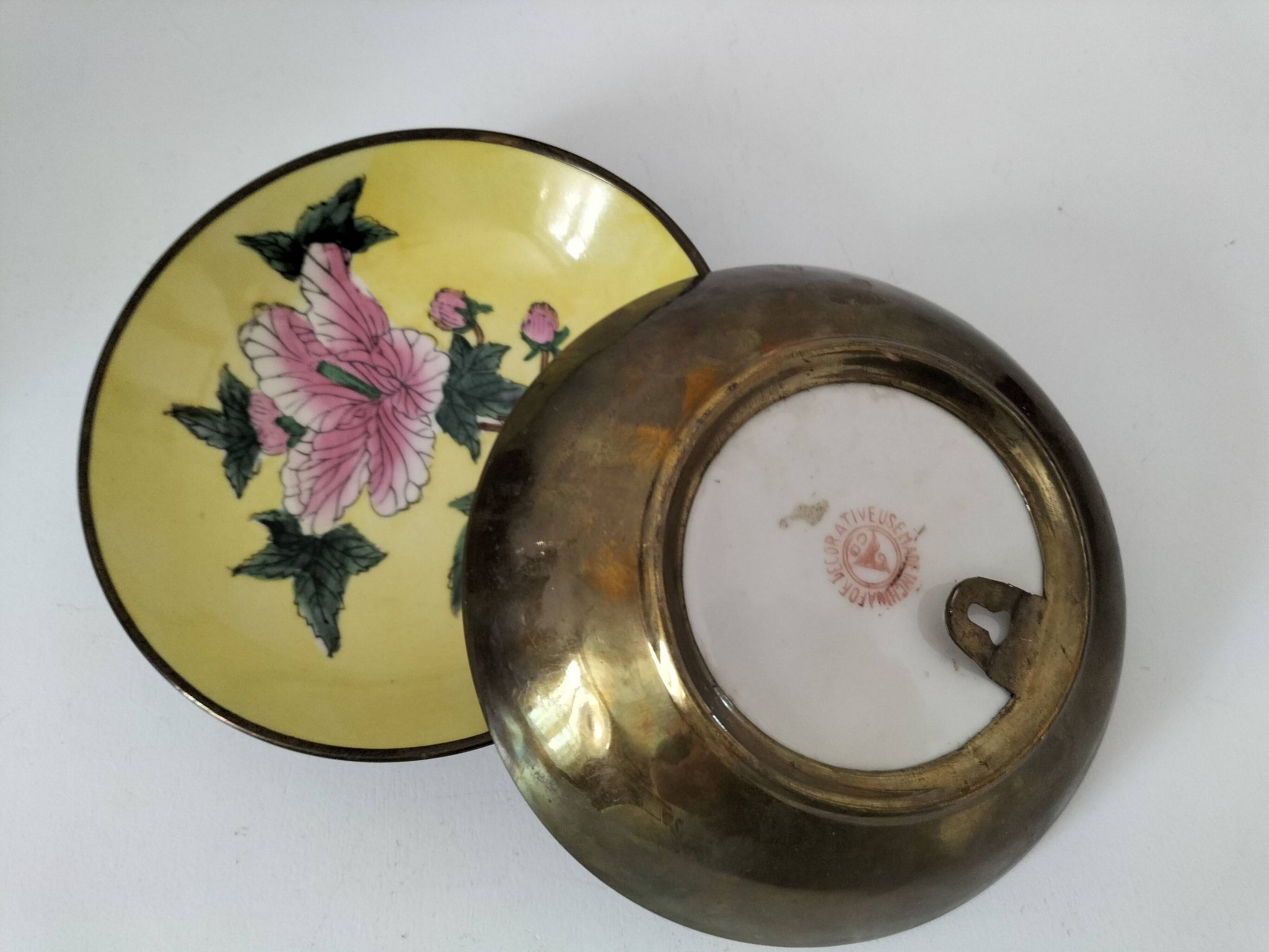 A pair of vintage Chinese decorative plates with floral designs on a yellow background.