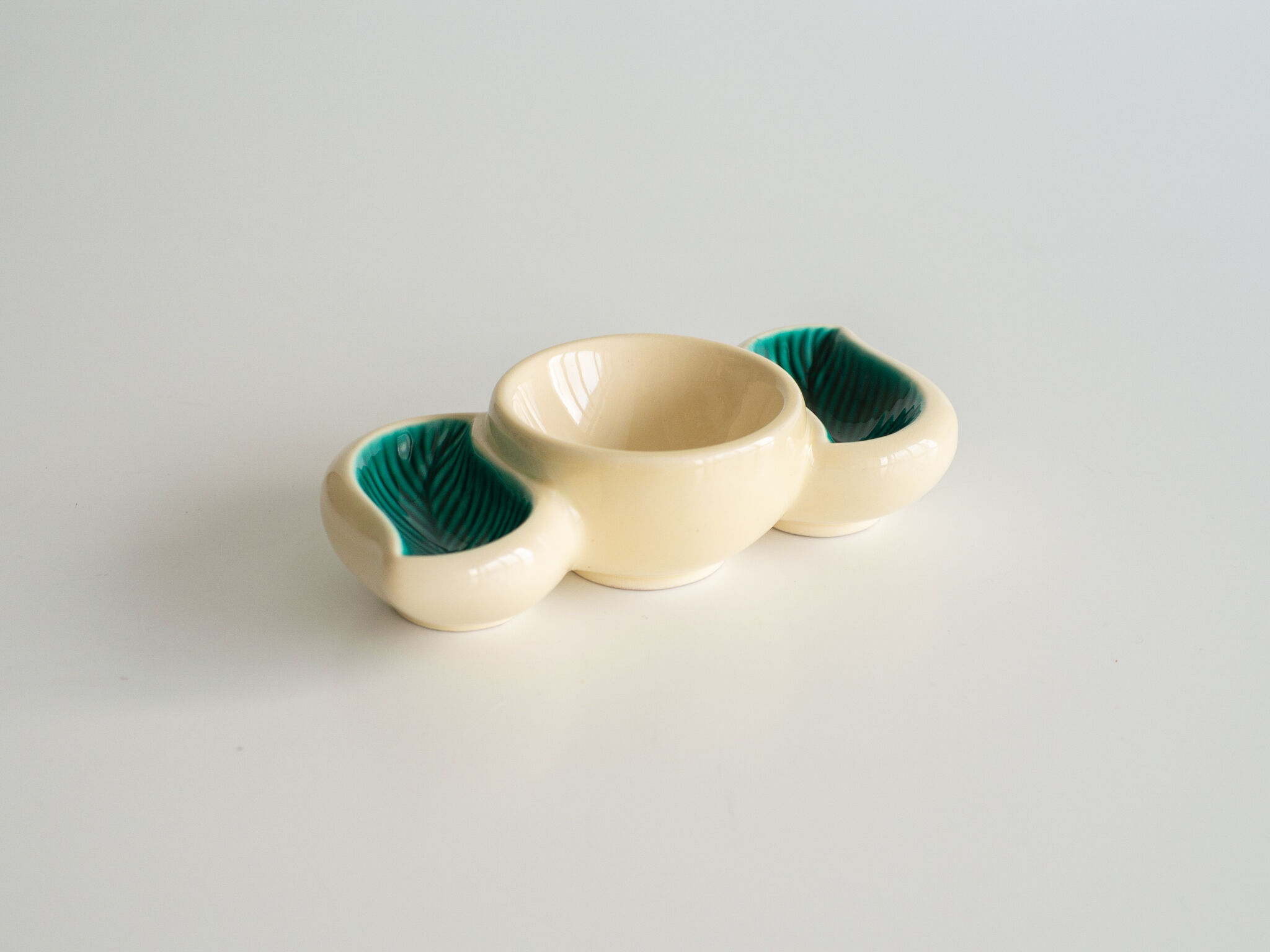 Small green and off-white ceramic ramekin