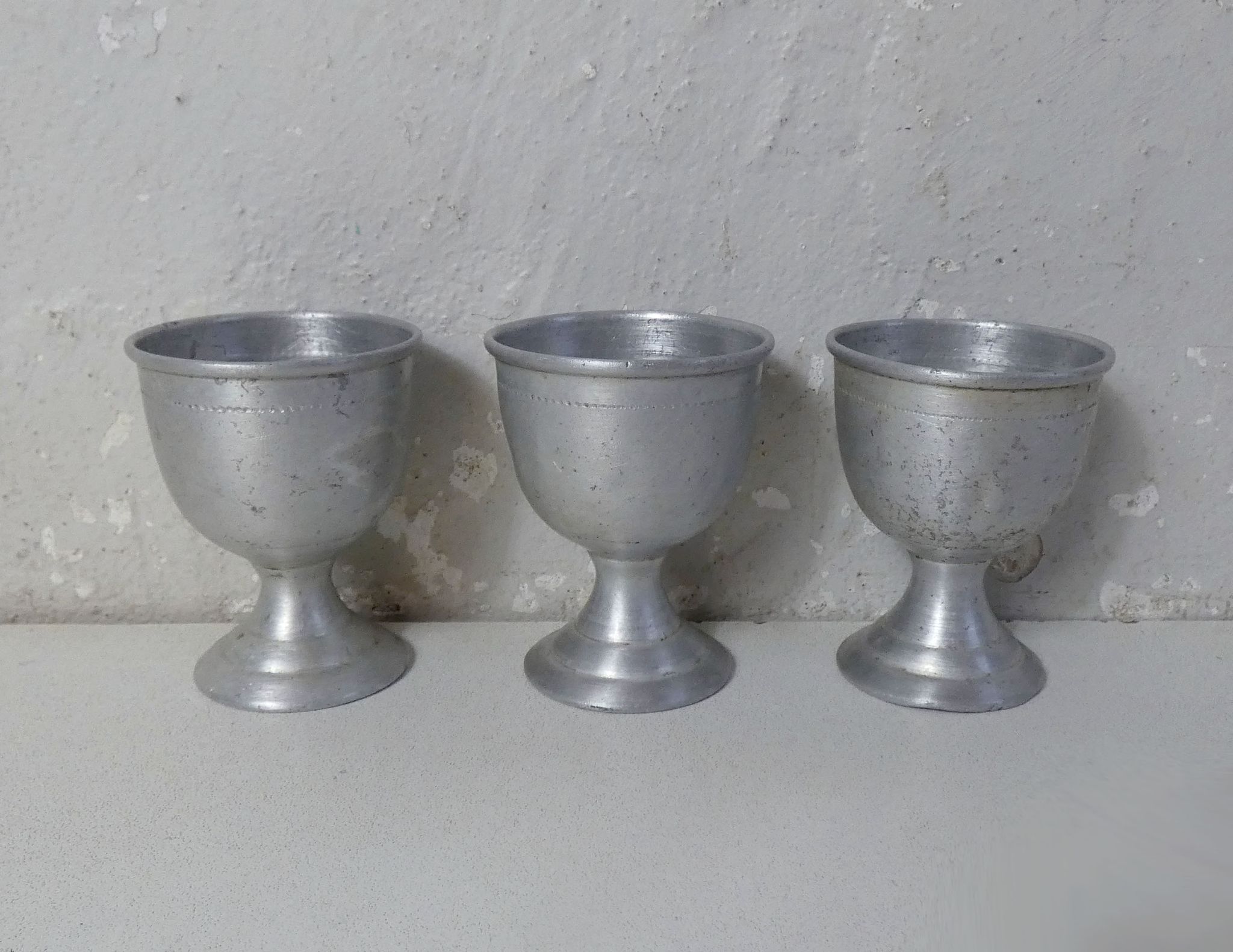3 old aluminum shells