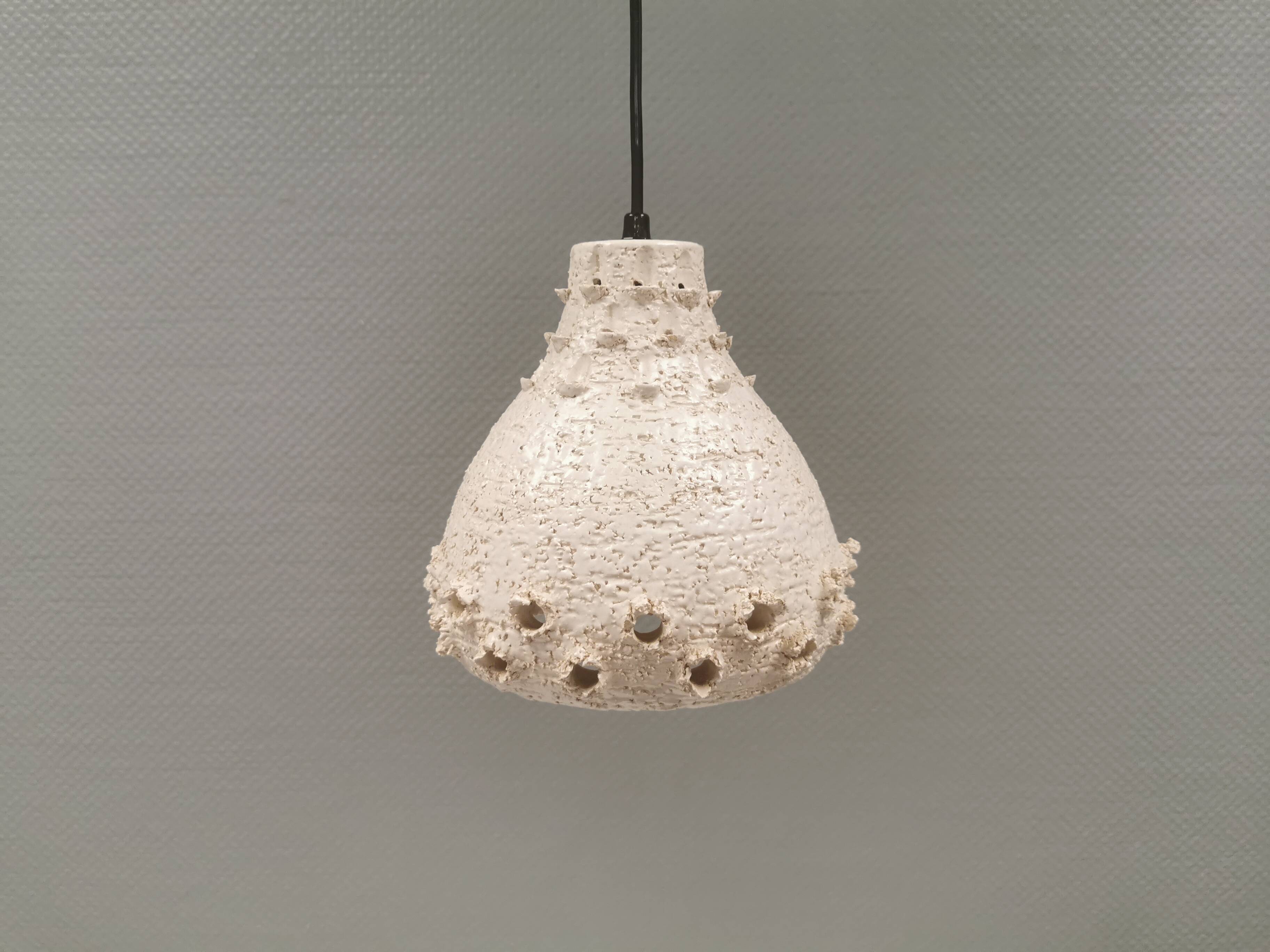 Ceramic hanging lamp in creamy white color that almost looks like a corral