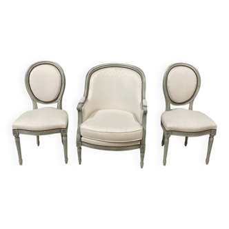 Armchair and 2 chairs set in Louis XVI style, light fabric, patinated wood.