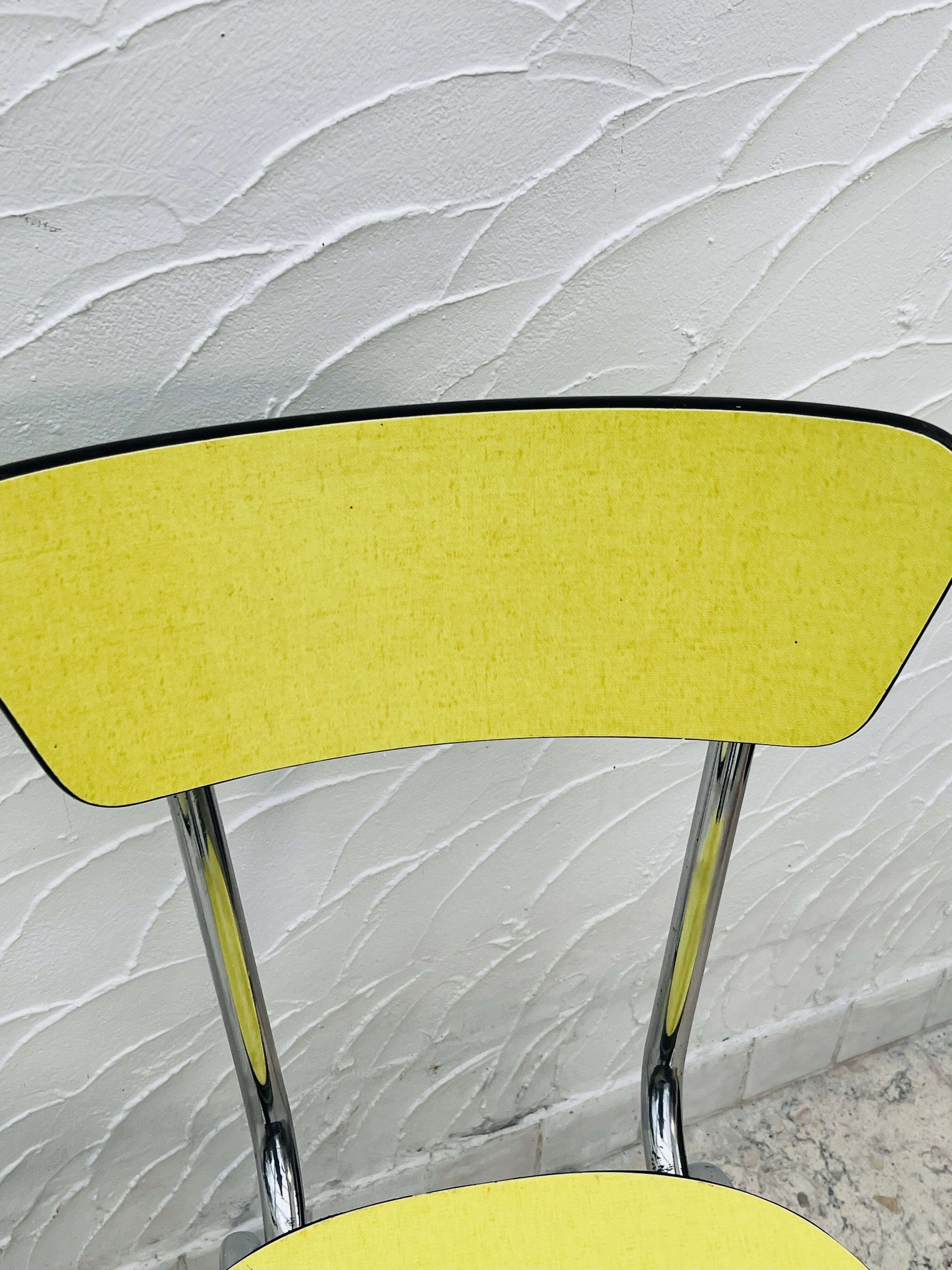 Pair of vintage yellow chrome Formica kitchen chairs.
