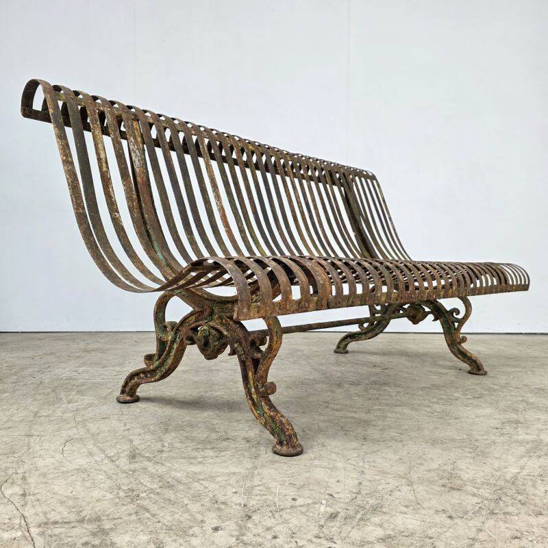 Cast iron garden bench from the late 19th century with slatted backrest.