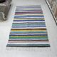 Vintage traditional nomadic kilim ethnic rug with multicoloured stripes.