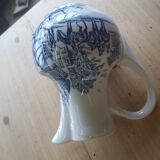 Small old pitcher in iron earth