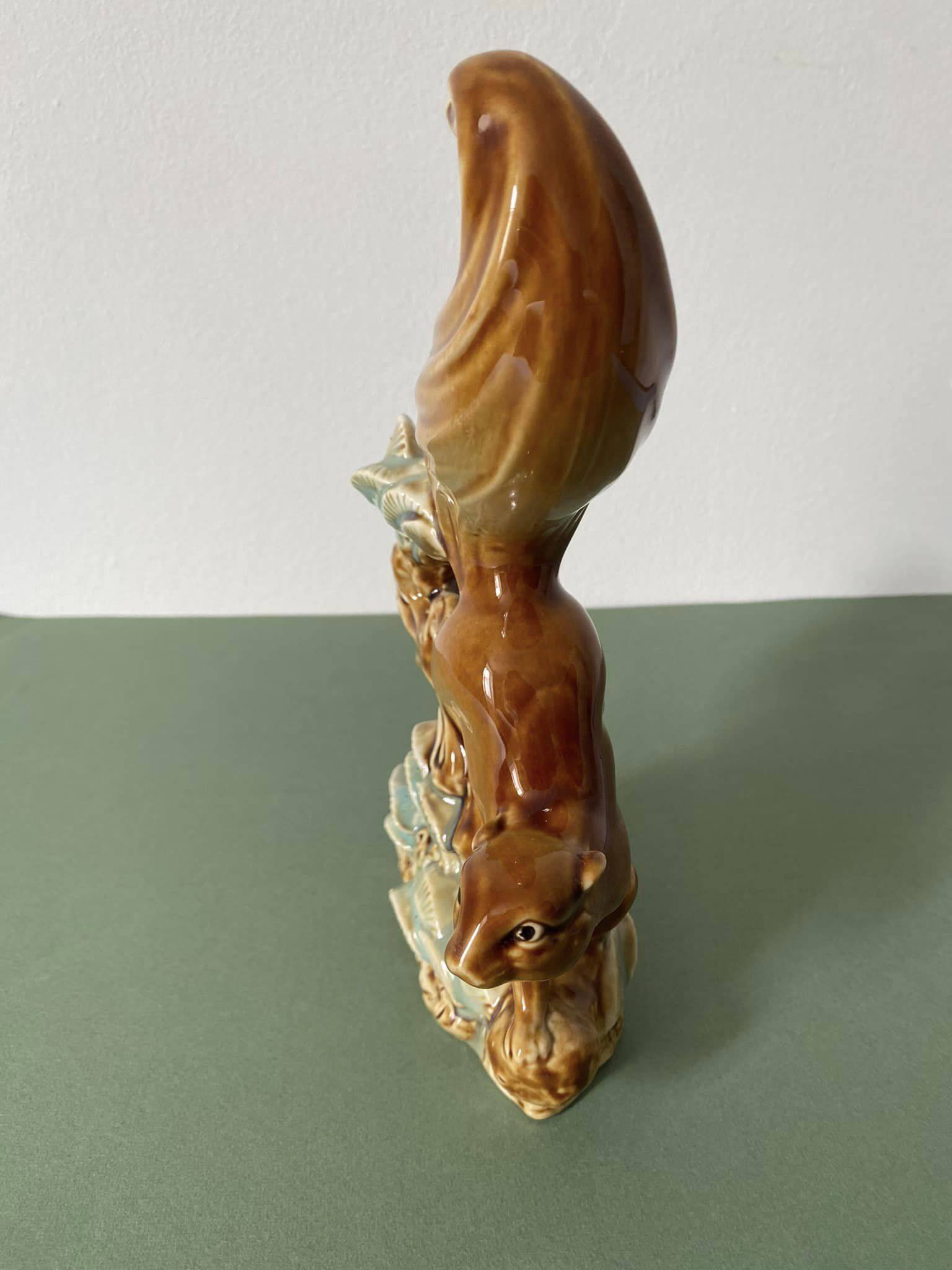 Ceramic squirrel on branch