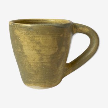 Handmade beige ceramic coffee cup