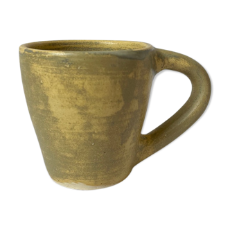 Handmade beige ceramic coffee cup