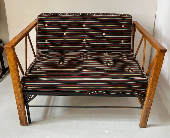 Two-seater bench convertible into a single bed.