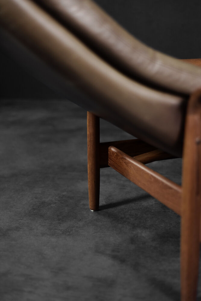 High teak and brown leather armchair with reclining backrest, mid-century Danish style, 1960s.
