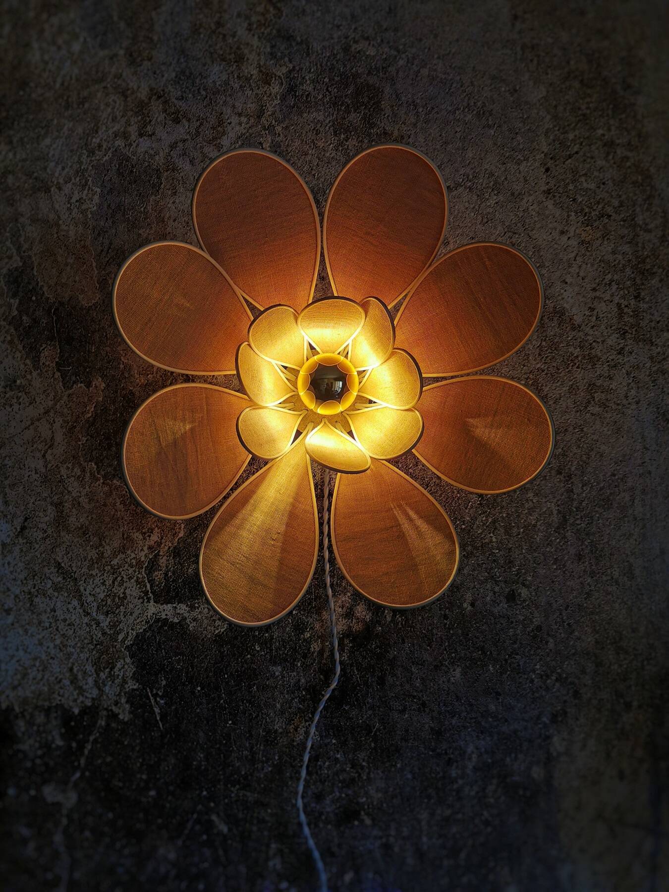 Flower wall light made of rattan and nude linen petals